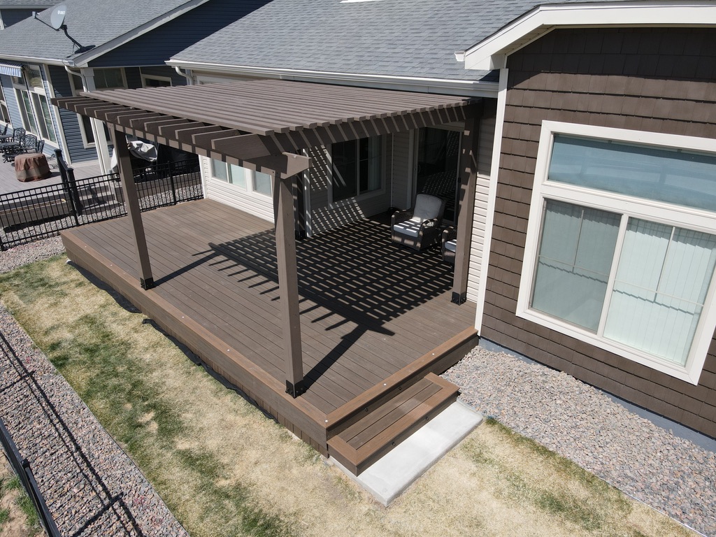 Elevated outdoor deck featuring a stylish pergola in Commerce, Michigan.