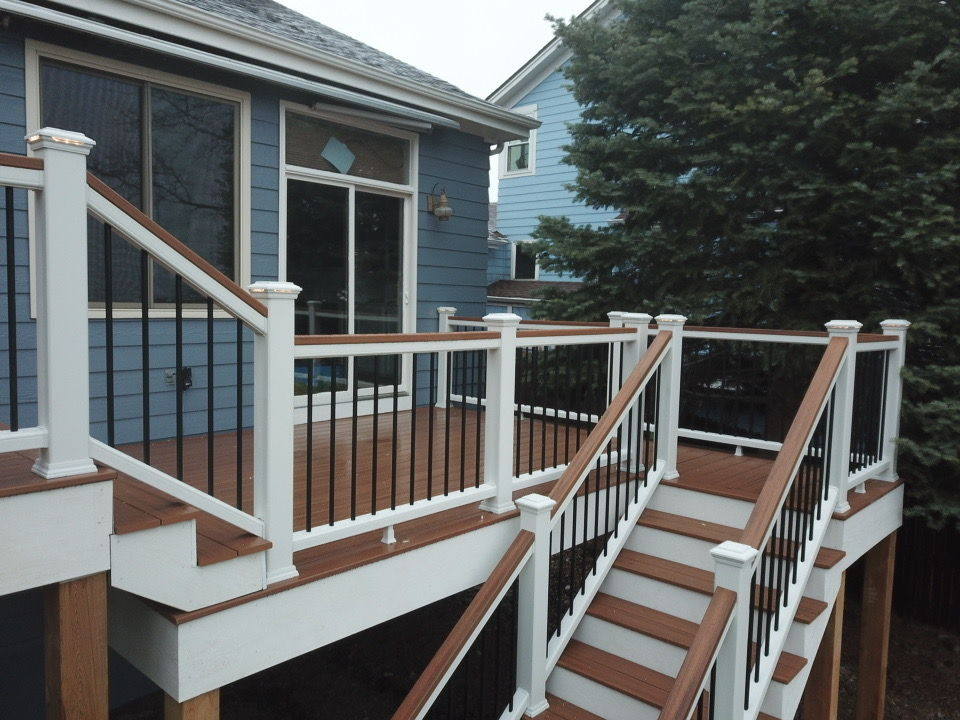 Luxury outdoor deck with sleek railings and a modern staircase in Denver, Colorado.