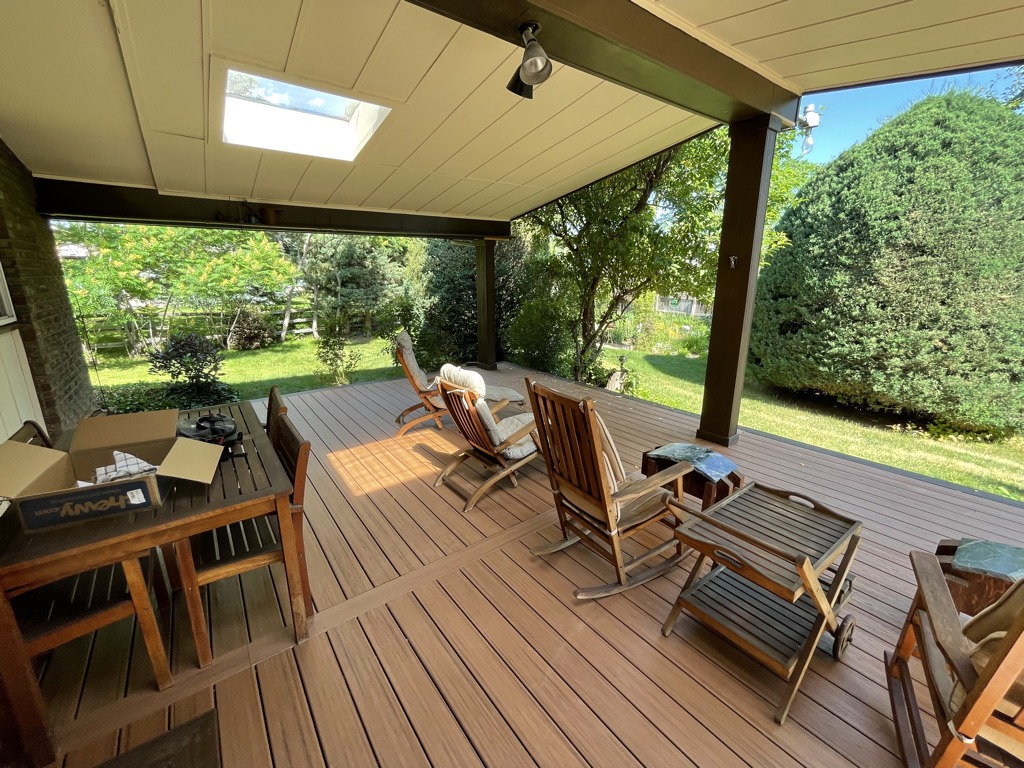 A custom-built outdoor deck with a covered area for shade and protection in Denver, Colorado.
