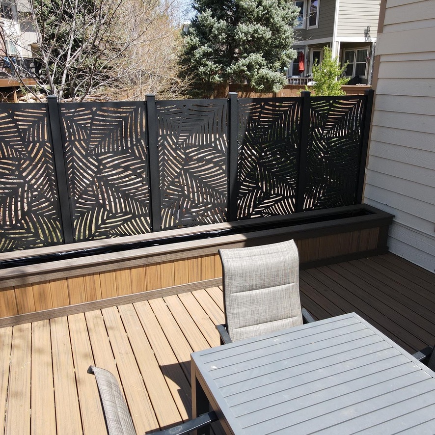 Stylish privacy fence surrounding a spacious deck with modern railings in Commerce, Michigan.